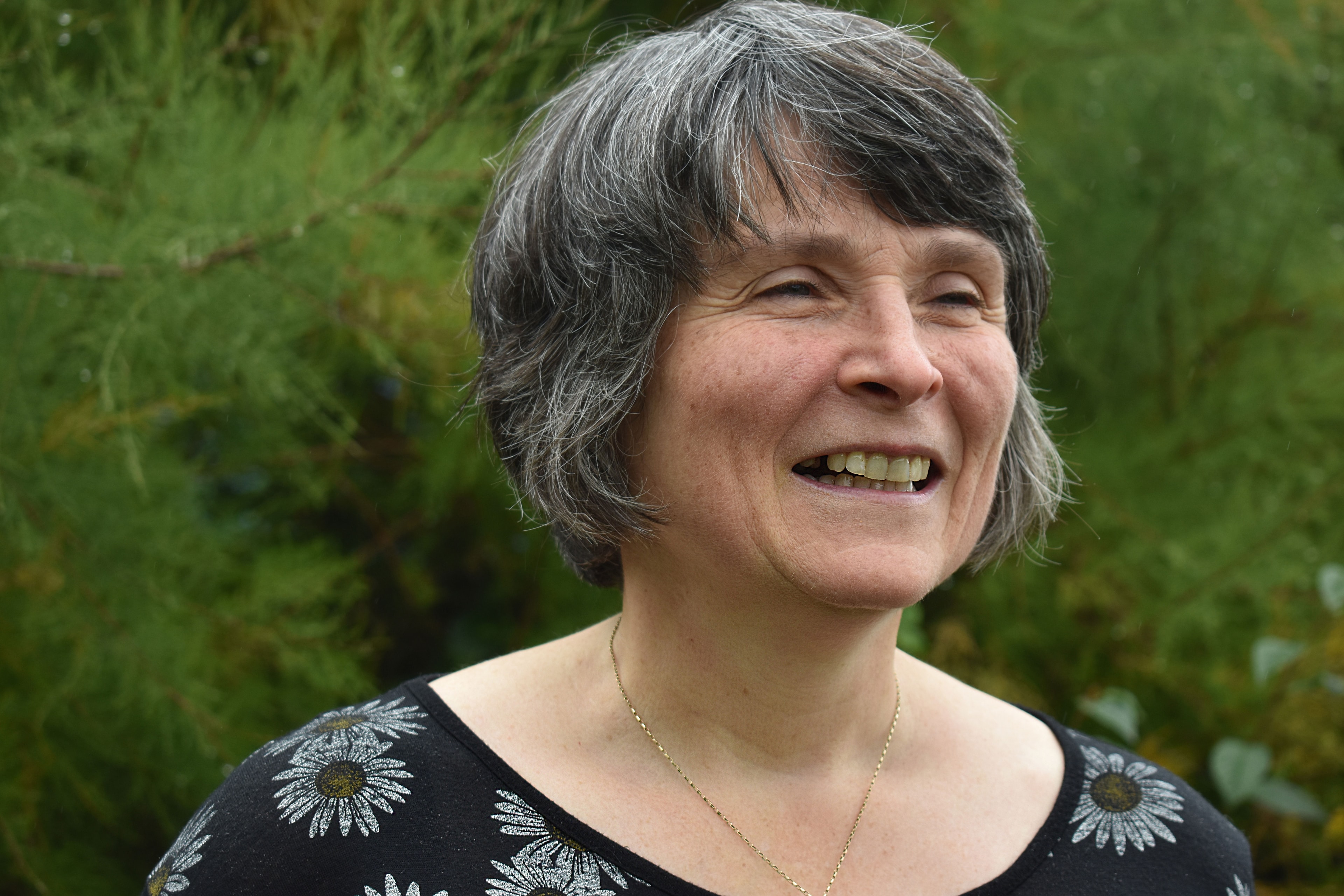 Helen Stone smiling in her garden